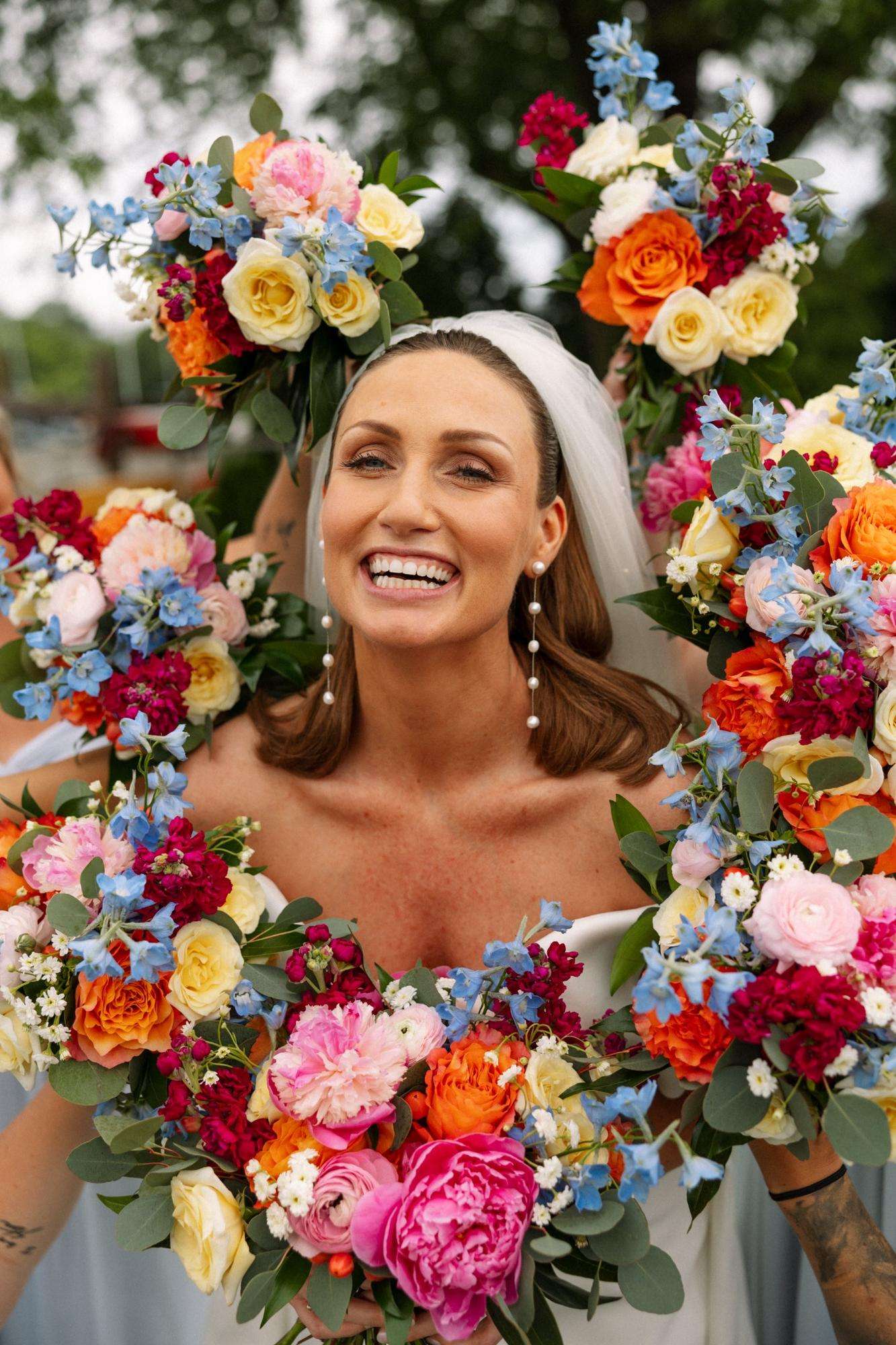Bride smiling as all her wedding bouquets surround her. Bride smiling as all her wedding bouquets surround her.