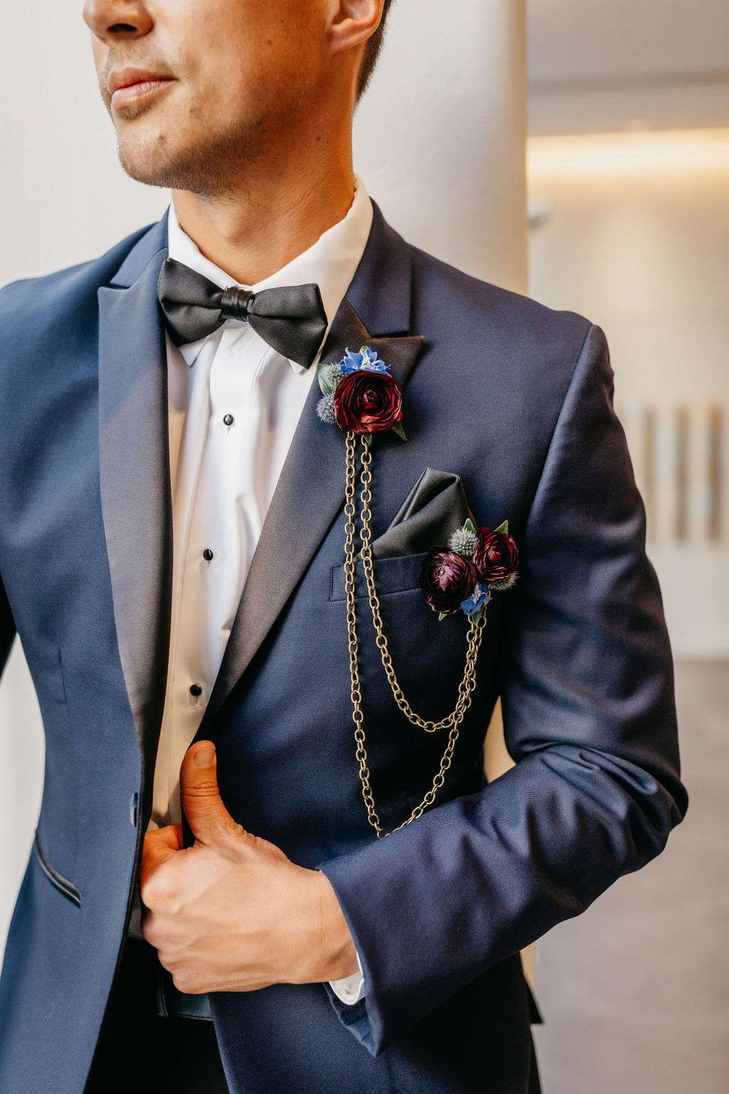 Unique boutonniere with chains and burgundy flowers. Unique boutonniere with chains and burgundy flowers.
