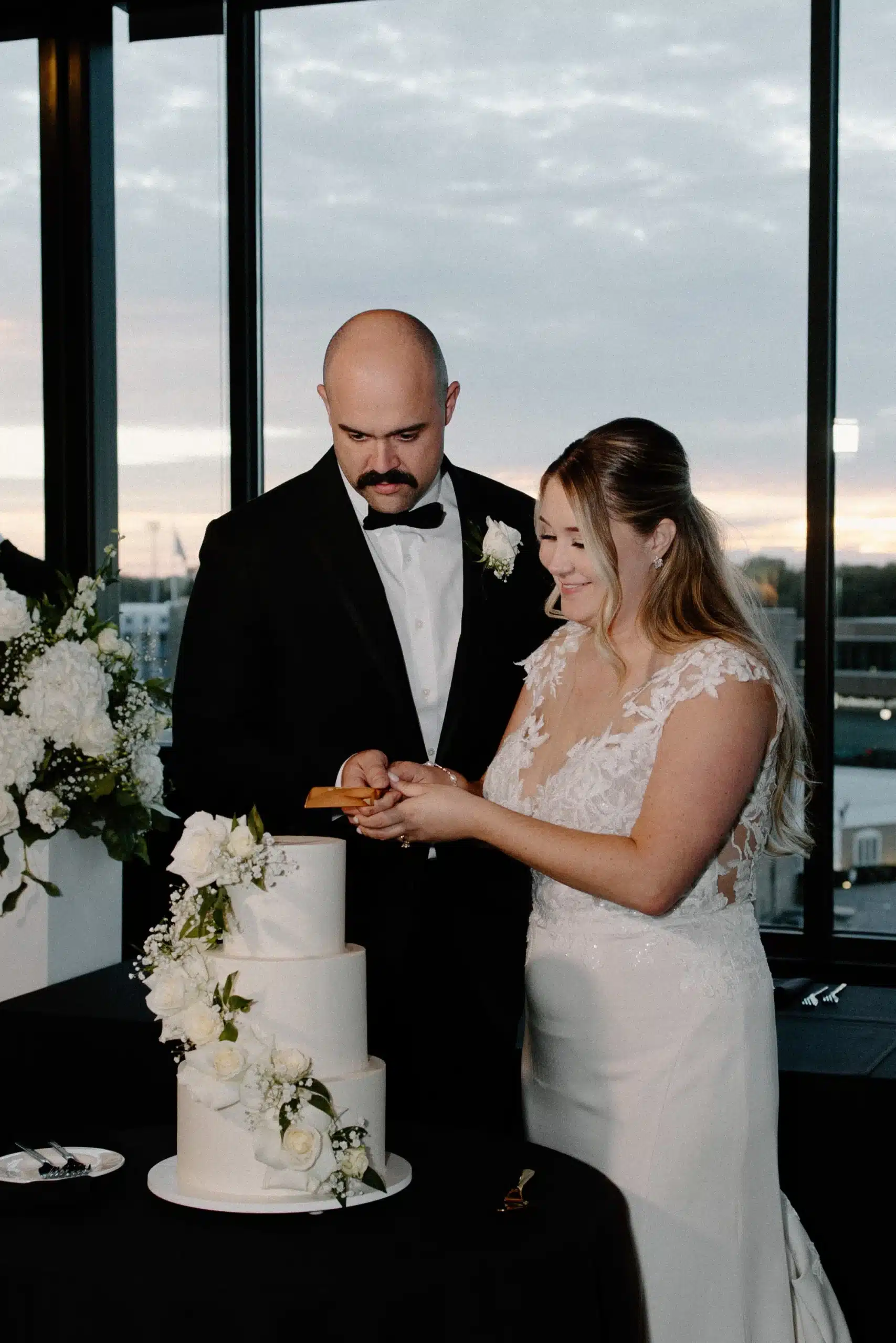 Bride and groom cutting cake at their wedding reception at Hotel Goodwin.