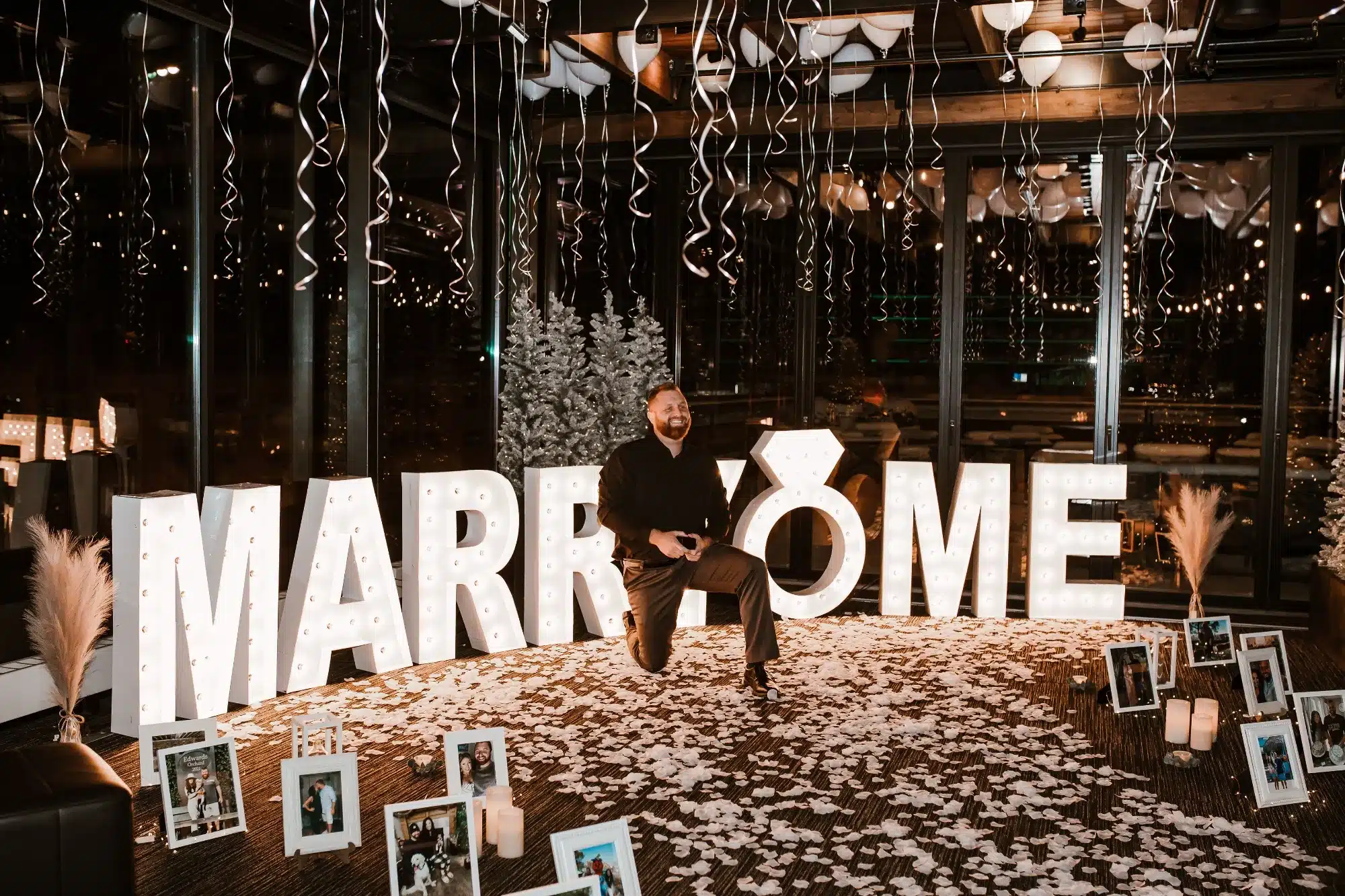 Grand proposal at Hotel Goodwin with Marry Me in the background in Marquee letters.