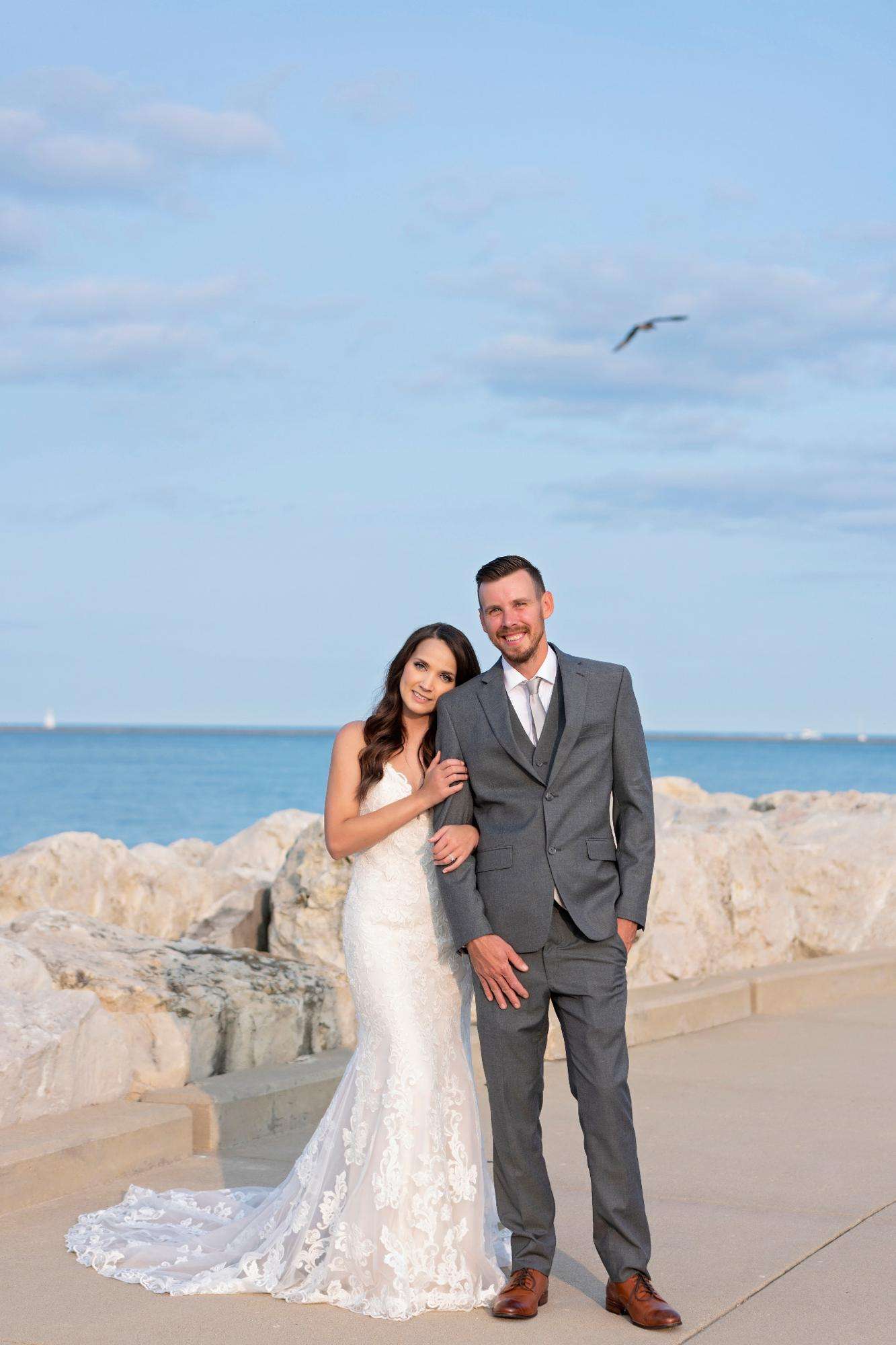 A lakeside portrait of a bride and groom basking in golden-hour light, beautifully captured by Allysha Noelle Photography.