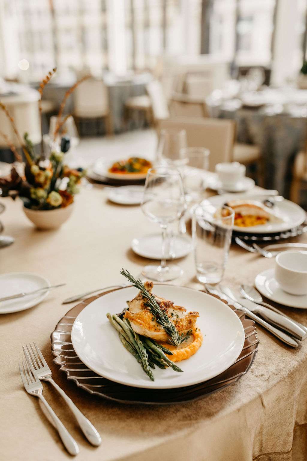 Rosemary Garlic Roasted Chicken plated on a beautiful charger by Resonance Food Co at Bradley Symphony Center. Rosemary Garlic Roasted Chicken plated on a beautiful charger by Resonance Food Co at Bradley Symphony Center.