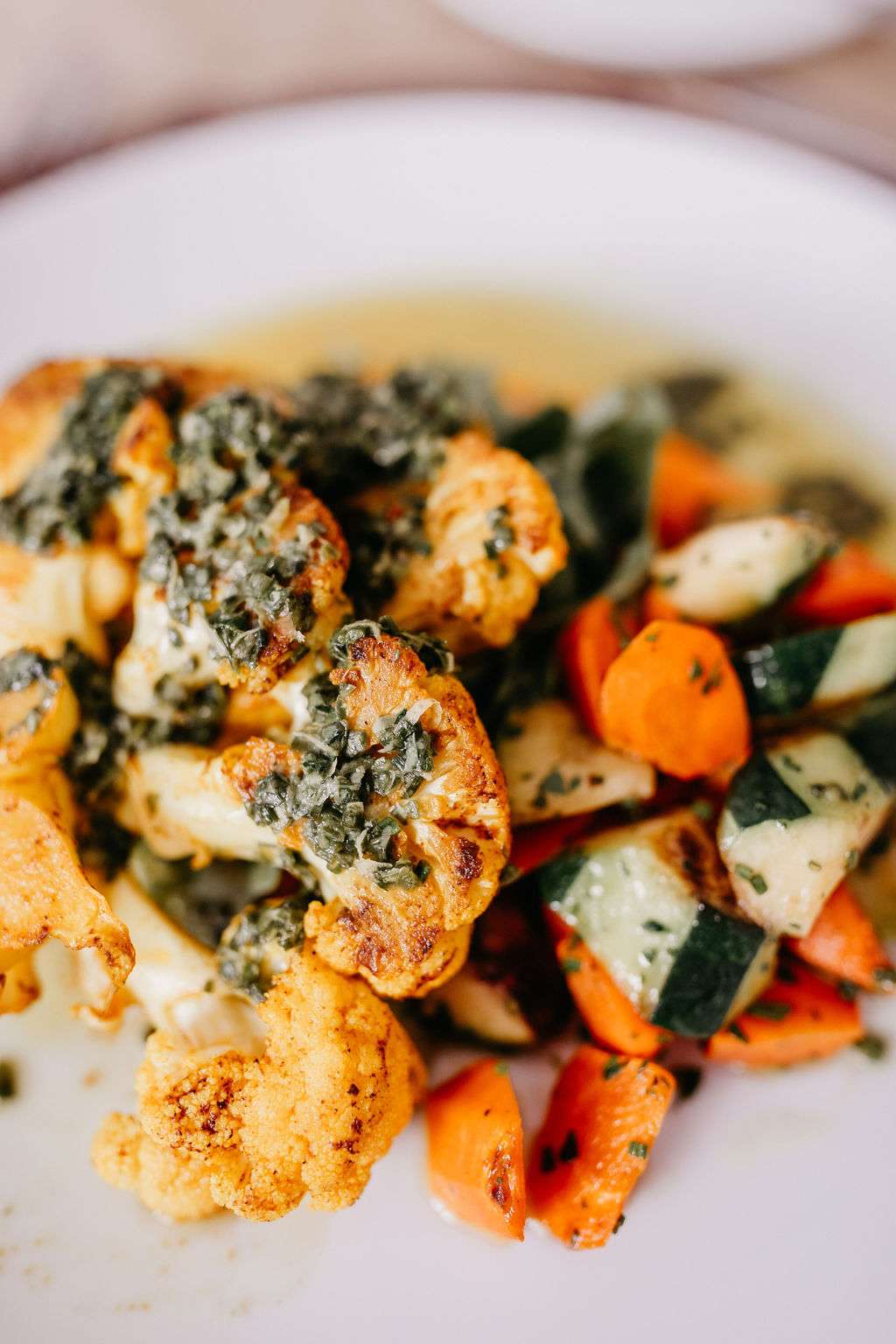 Vegan, Charred Cauliflower Steak with Baby Zucchini, Roasted Red Pepper Chimichurri by Resonance Food Co. Vegan, Charred Cauliflower Steak with Baby Zucchini, Roasted Red Pepper Chimichurri by Resonance Food Co.