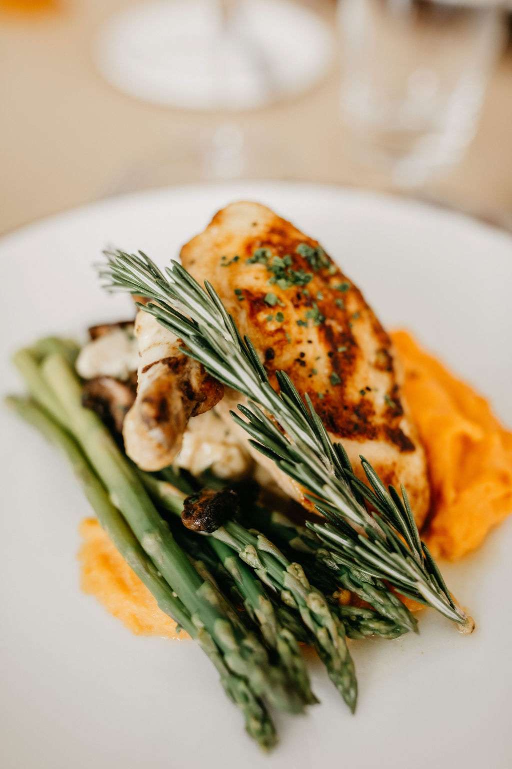 Rosemary Garlic Roasted Chicken plated on a beautiful charger by Resonance Food Co at Bradley Symphony Center. Rosemary Garlic Roasted Chicken plated on a beautiful charger by Resonance Food Co at Bradley Symphony Center.