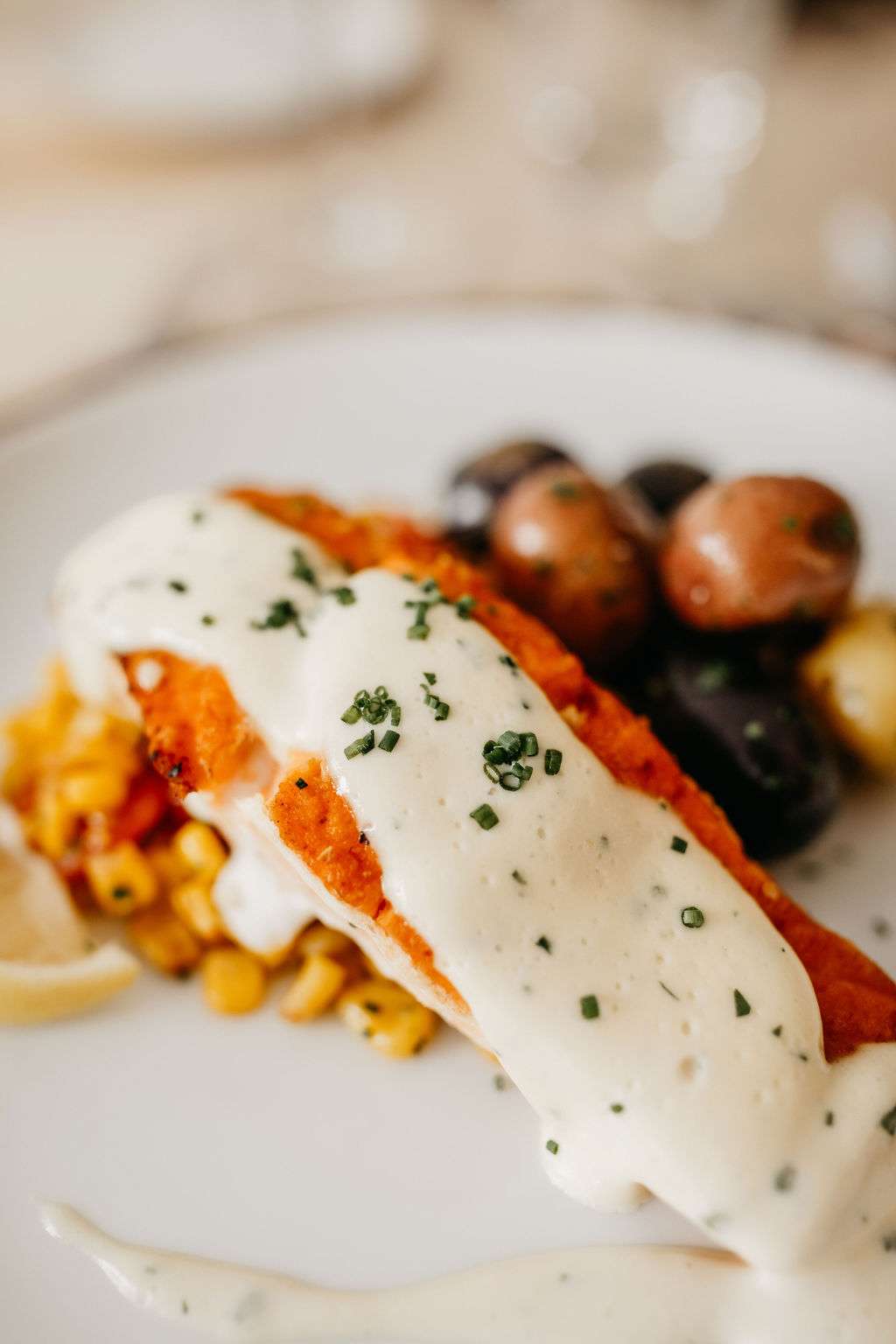 Pan-Roasted Atlantic Salmon served with heirloom potatoes and sweet corner by Resonance Food Co at Bradley Symphony Center. Pan-Roasted Atlantic Salmon served with heirloom potatoes and sweet corner by Resonance Food Co at Bradley Symphony Center.