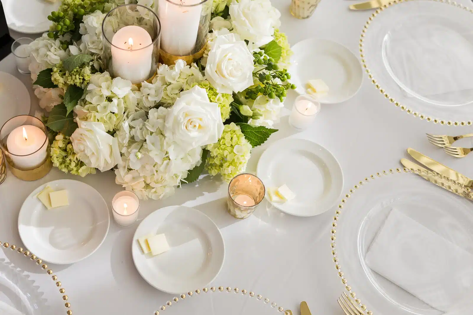 Above shot of wedding table decor all in white.