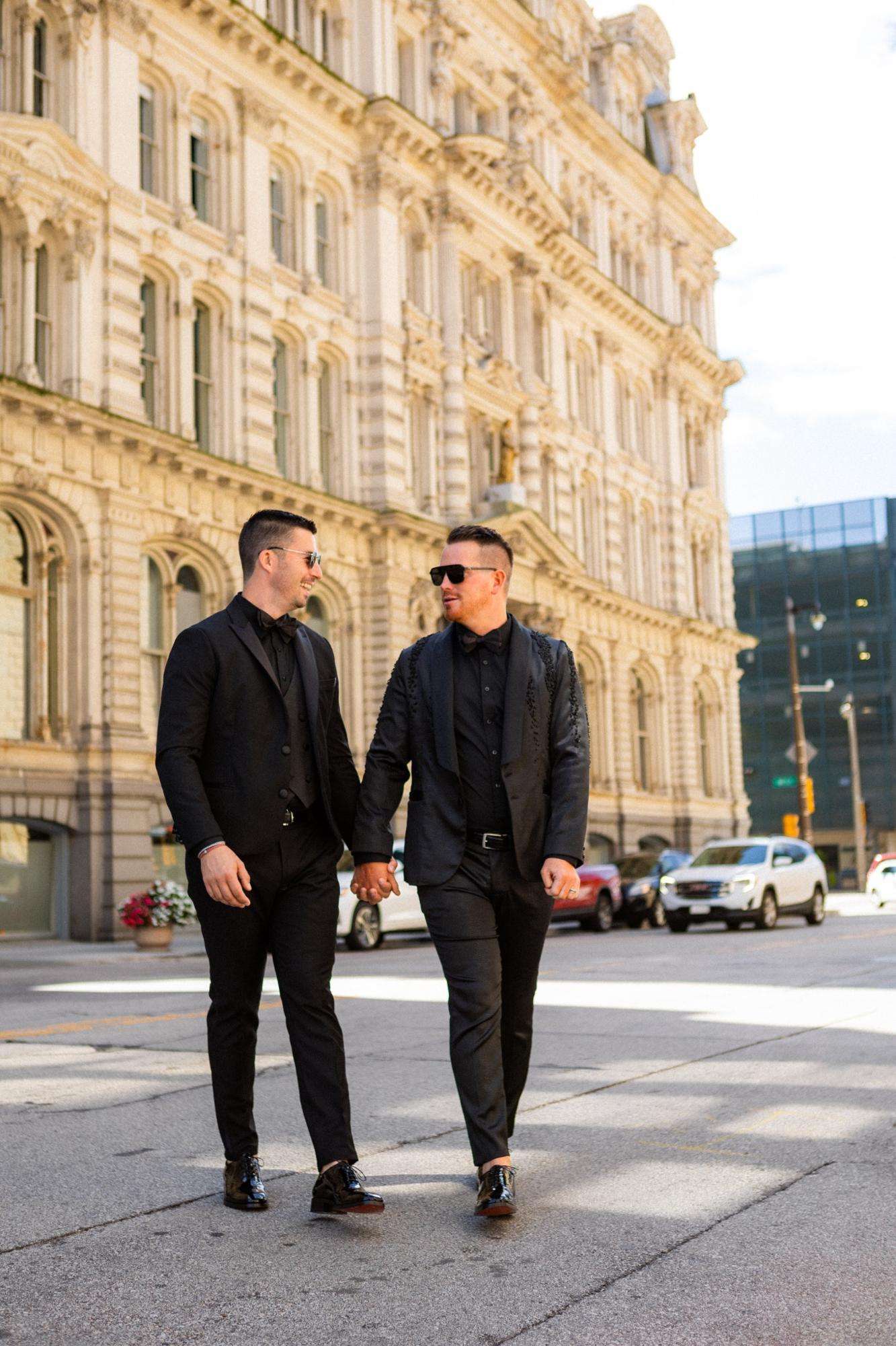Grooms striking a pose together in the city. Grooms striking a pose together in the city.