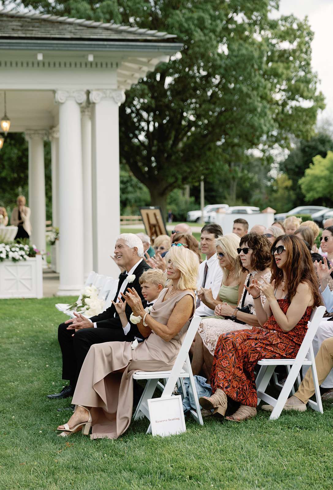 Guests watching a wedding ceremony at Lake Park Bistro on the lawn. Guests watching a wedding ceremony at Lake Park Bistro on the lawn.