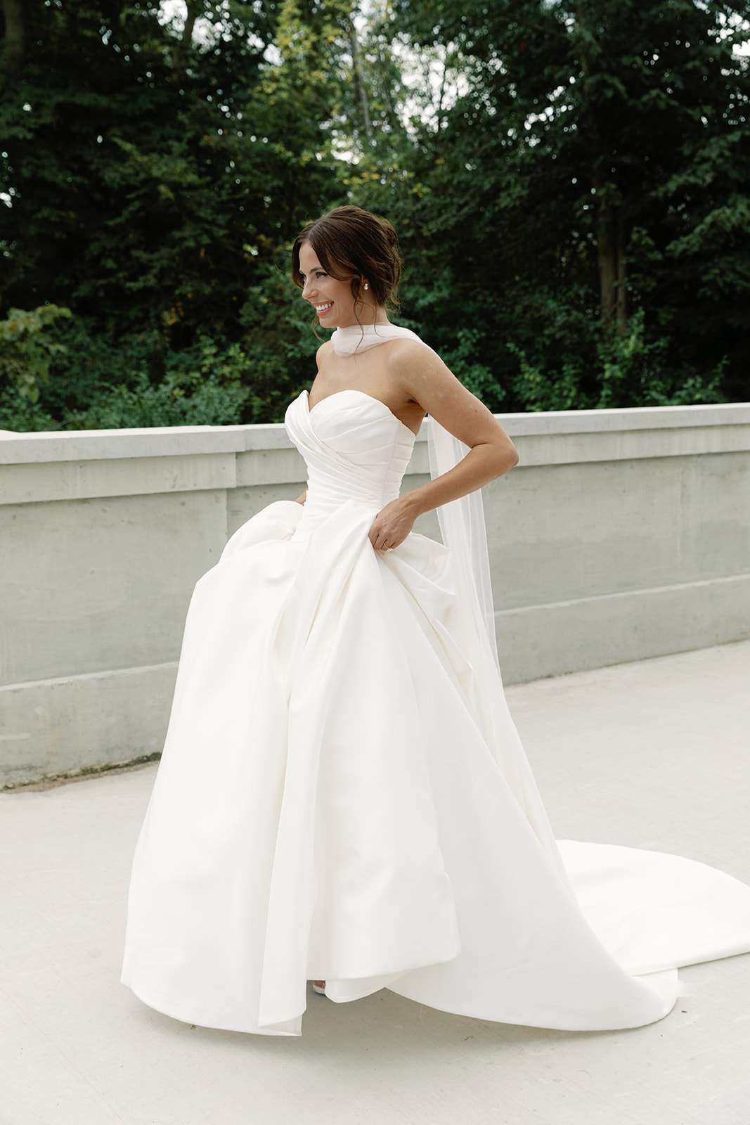 Bride in a white strapless ballgown with sash around her neck. Bride in a white strapless ballgown with sash around her neck.