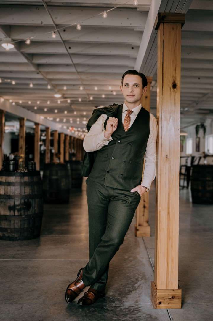 Groom posing in the downstairs parlor of The Bowery Barn.