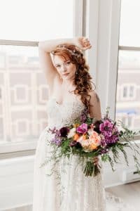 red head bride holding colorful purple wedding bouquet. red head bride holding colorful purple wedding bouquet.