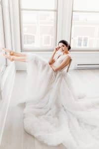 Bride sitting in chair with windows surrounding her. Bride sitting in chair with windows surrounding her.