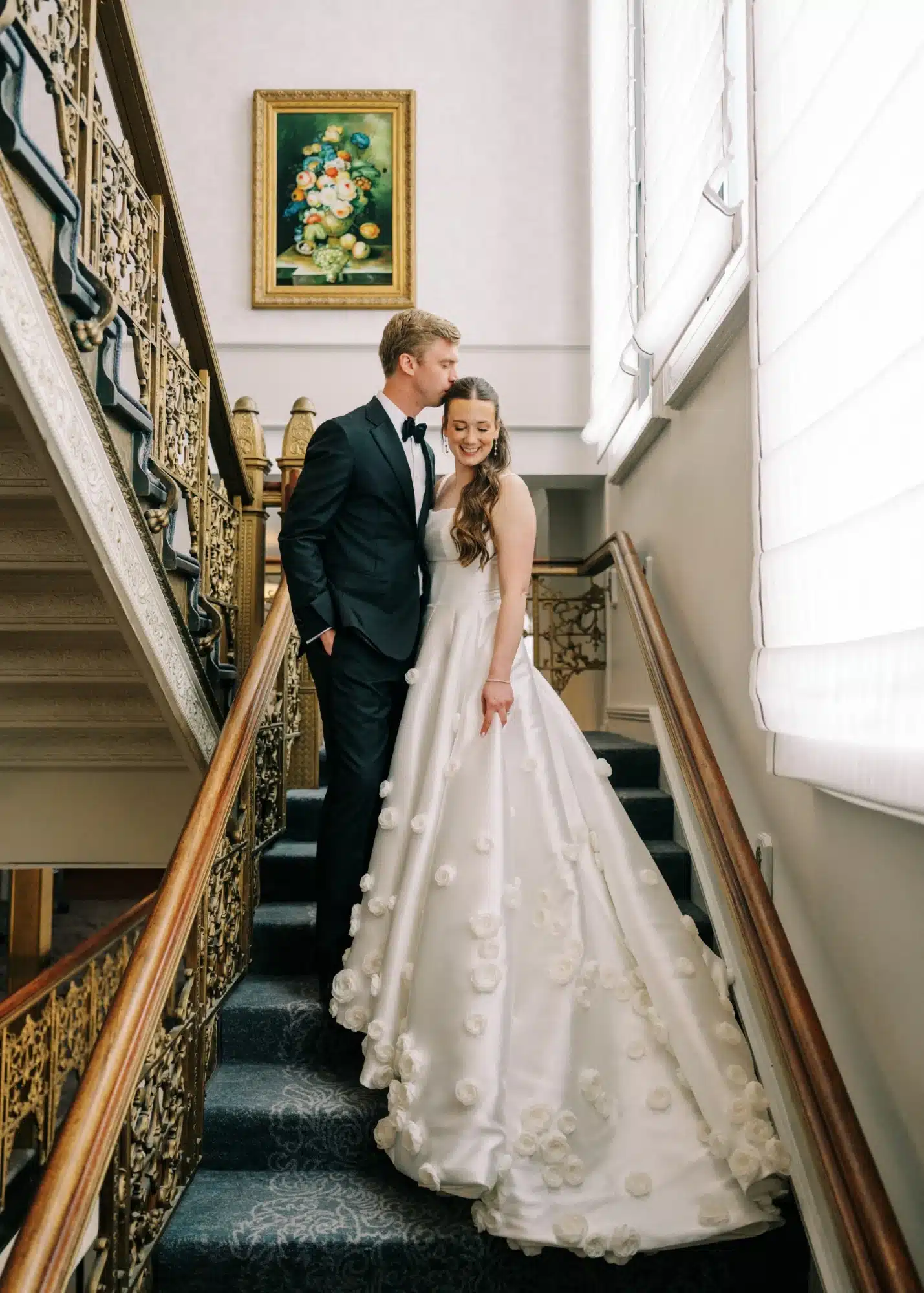 Bride and groom standing on historic Pfister Hotel stairs. Bride and groom standing on historic Pfister Hotel stairs.