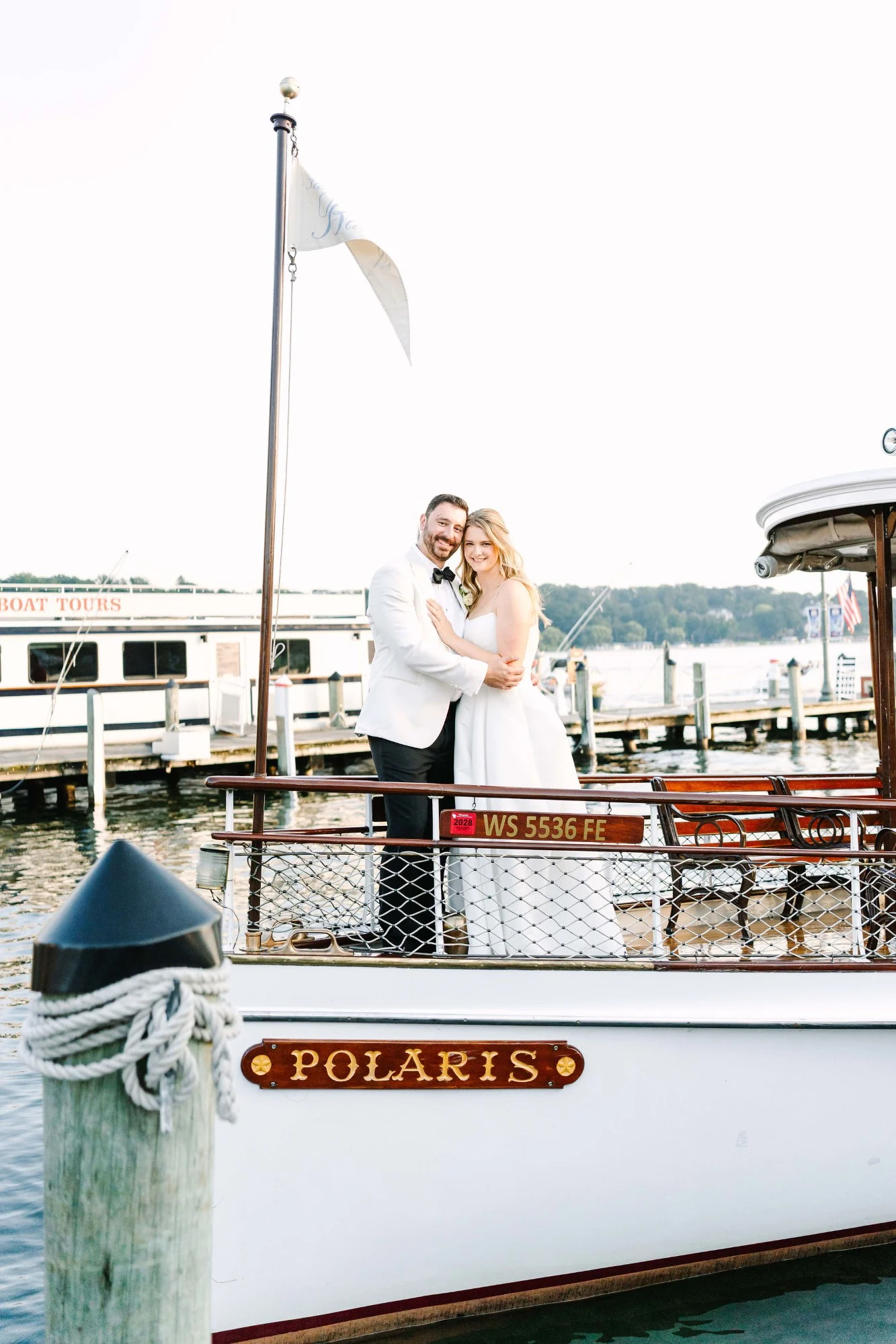 Bride and groom pose on the bow of the Polaris boat from Lake Geneva Cruise Line. Bride and groom pose on the bow of the Polaris boat from Lake Geneva Cruise Line.
