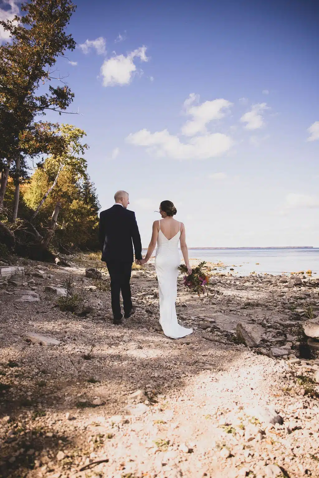 Bride and groom walking along Peninsula State Park in Door County. Bride and groom walking along Peninsula State Park in Door County.