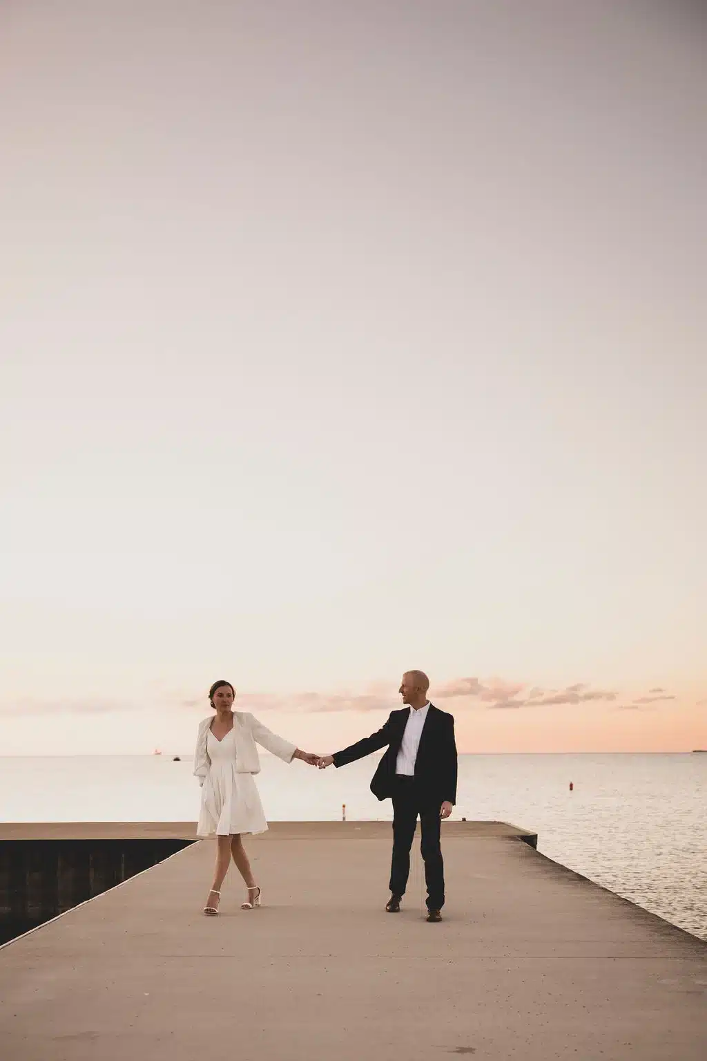 Wild-Elegance-Photography-Door-County-Elopement-(428of461) bride and groom dance on the pier in door county, wi.