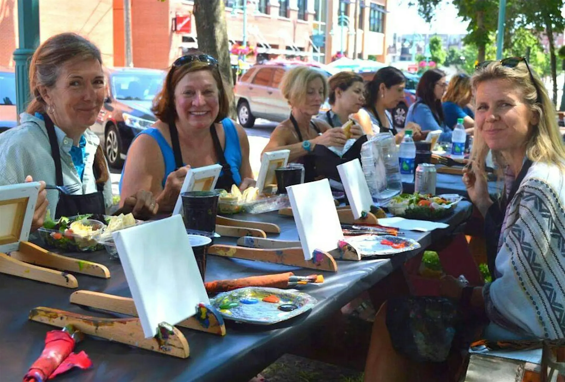 Girls doing wine sipping and painting and Bars and Recs Milwaukee event.