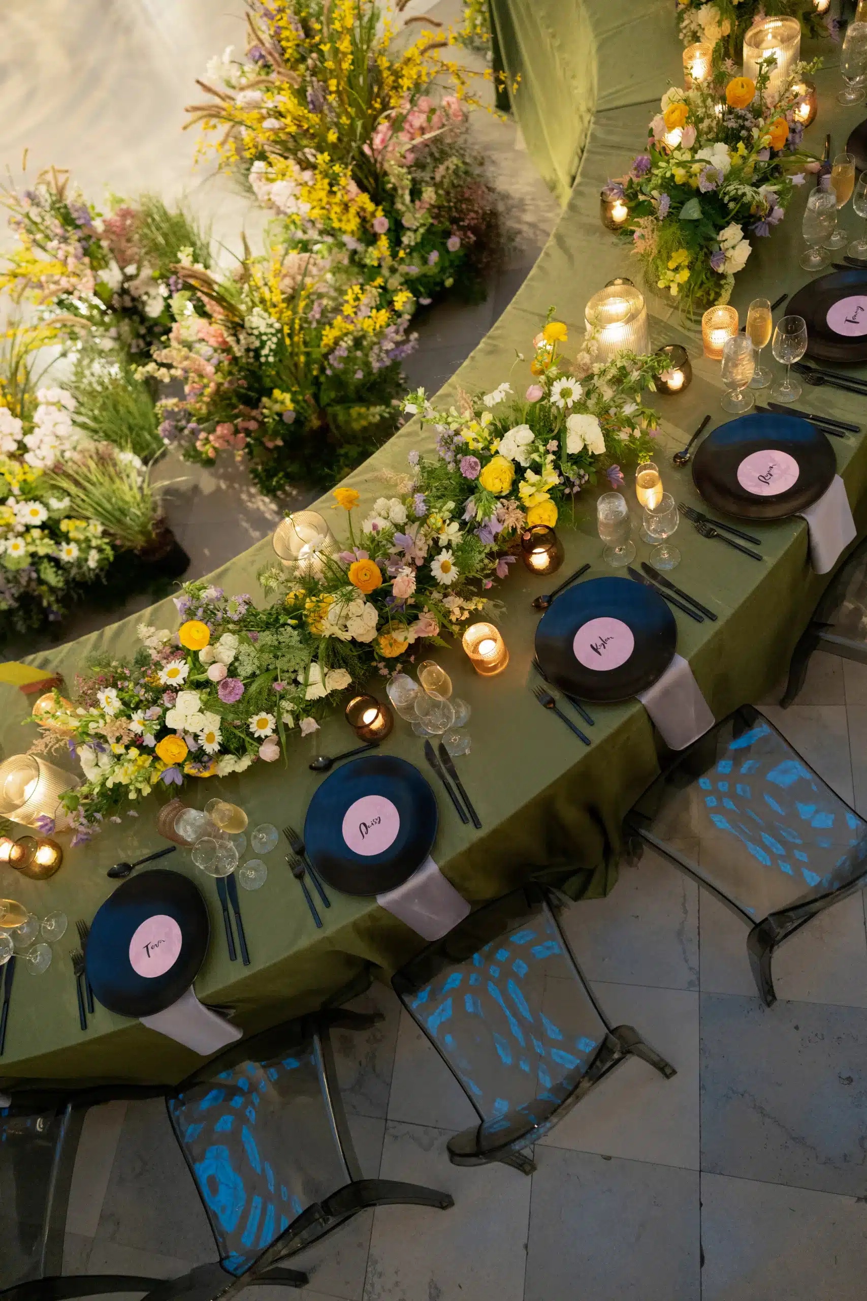 Serpentine Table with green linens, soft pink flowers and colorful dinnerware by Estera Events. Serpentine Table with green linens, soft pink flowers and colorful dinnerware by Estera Events.