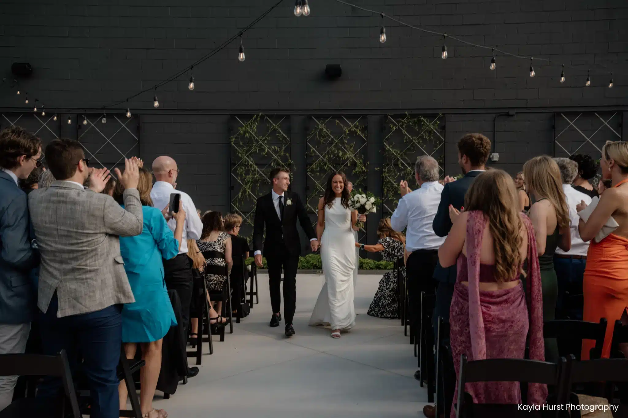 Wedding Ceremony at Saz’s South Second brand new patio with black accent wall. Wedding Ceremony at Saz's South Second brand new patio with black accent wall.