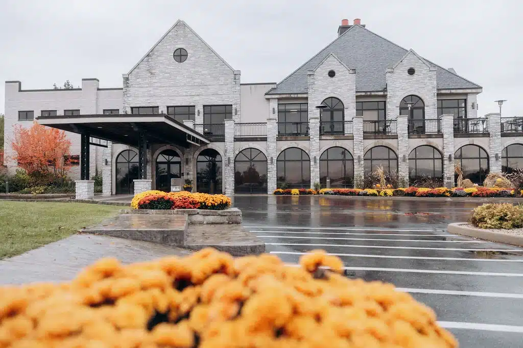 Outside view of The LEgend at Brandybrook on a fall day. Landscaping covered in fall colored mums. Outside view of The LEgend at Brandybrook on a fall day. Landscaping covered in fall colored mums.