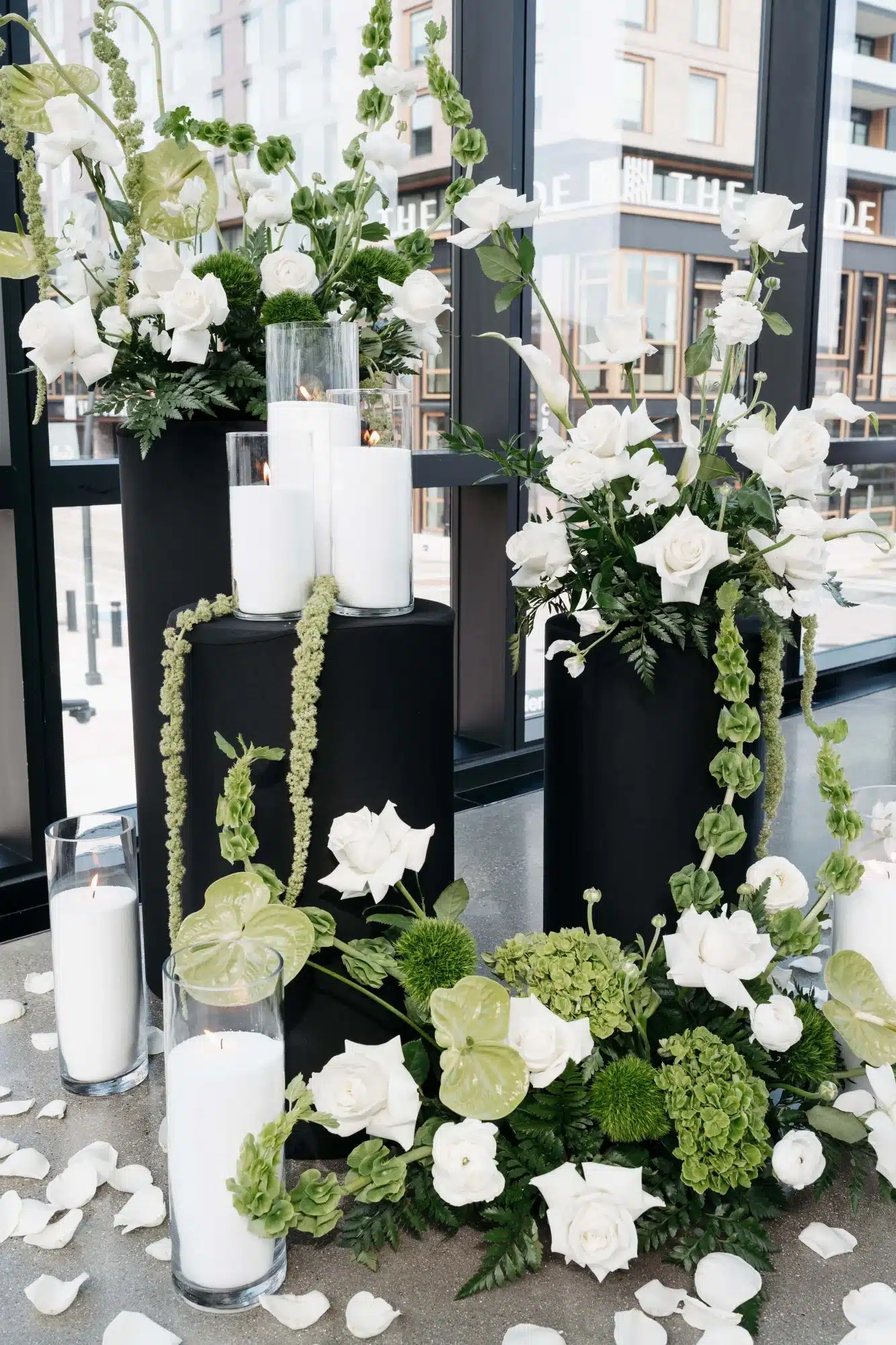 Stunning floral arrangements by Reflections of You featuring a black, white and greenery color palette with candles. Stunning floral arrangements by Reflections of You featuring a black, white and greenery color palette with candles.