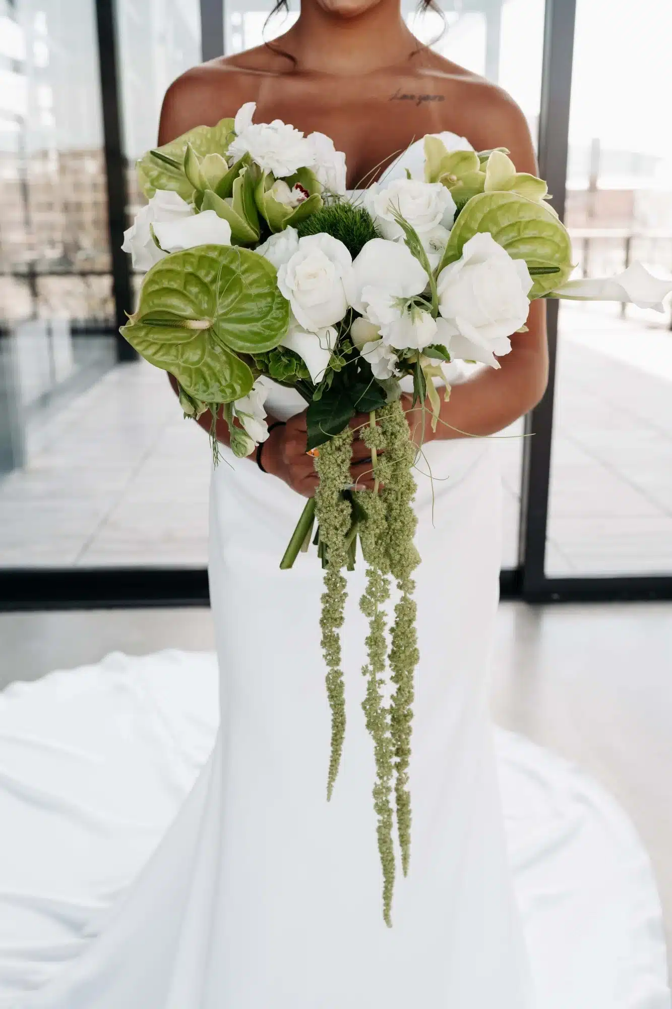 Wedding bouquet with draped greenery, large green leaves and white roses. Wedding bouquet with draped greenery, large green leaves and white roses.