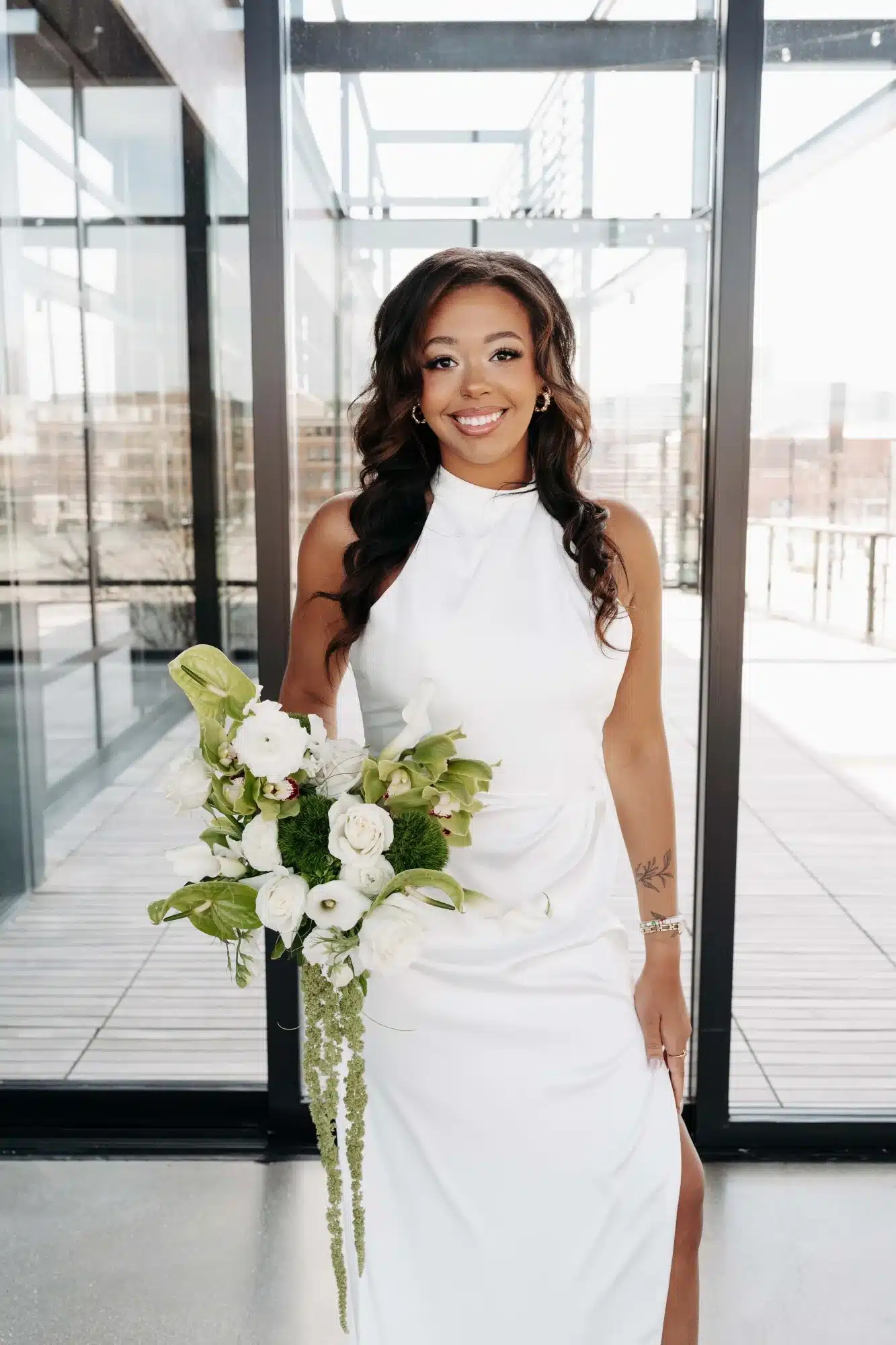 Bride in simple white halter gown with high slit from Miss Ruby Bridal Boutique. Bride in simple white halter gown with high slit from Miss Ruby Bridal Boutique.