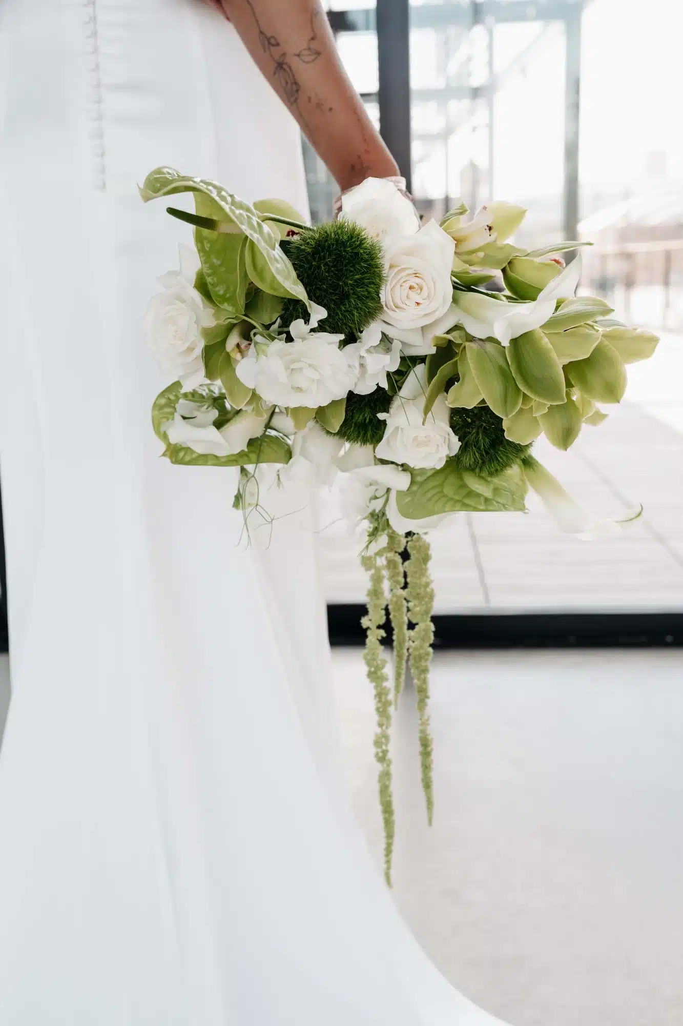 White roses and greenery accents wedding bouquet from Reflections of You. White roses and greenery accents wedding bouquet from Reflections of You.
