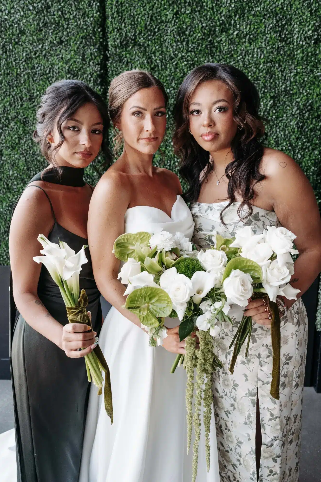 Bride with her bridesmaids all in a palette of green dresses and white and greenery floral bouquets. Bride with her bridesmaids all in a palette of green dresses and white and greenery floral bouquets.