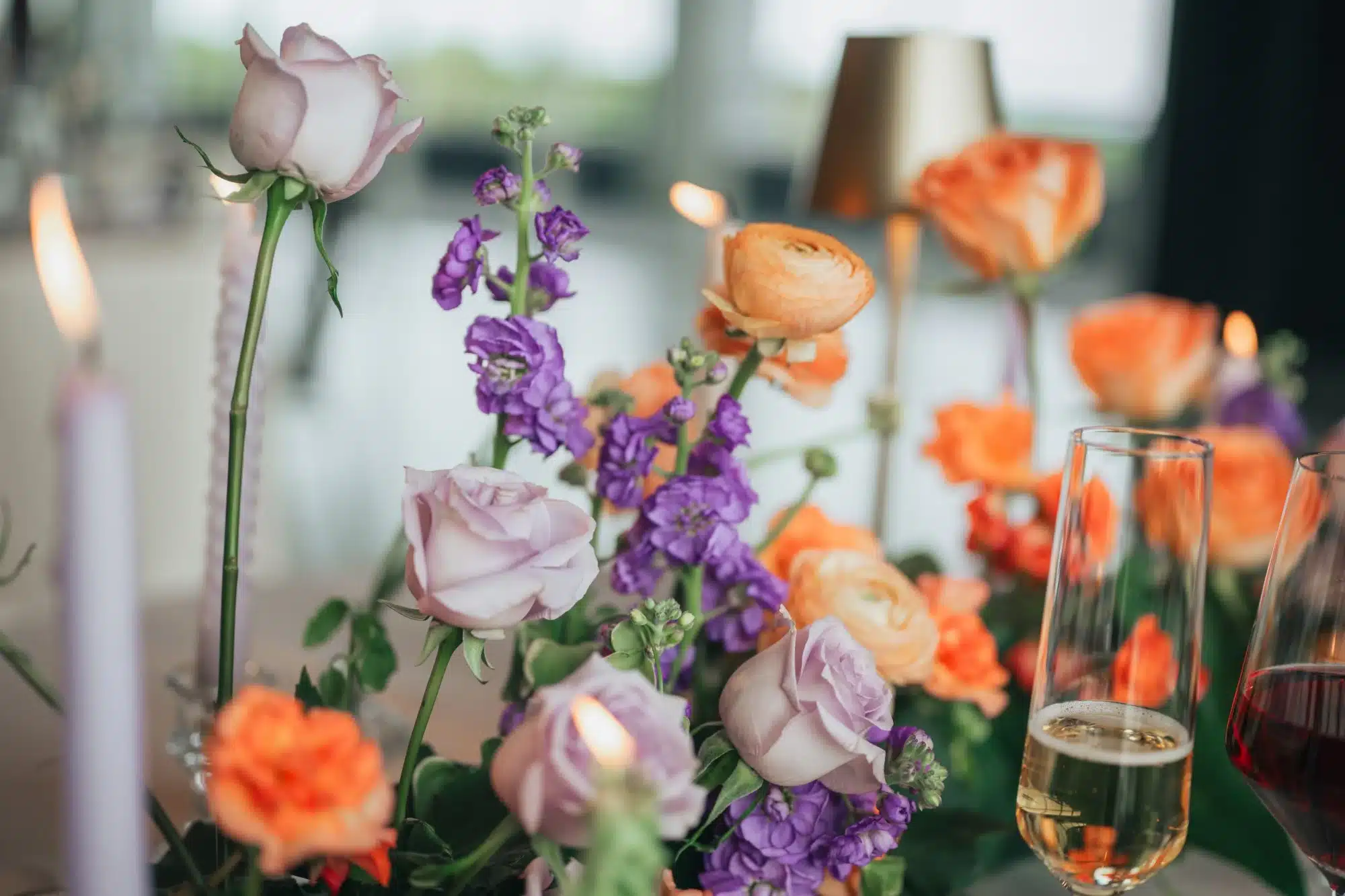 Floral arrangements by Vines and Violet with purple and orange flowers. Floral arrangements by Vines and Violet with purple and orange flowers.