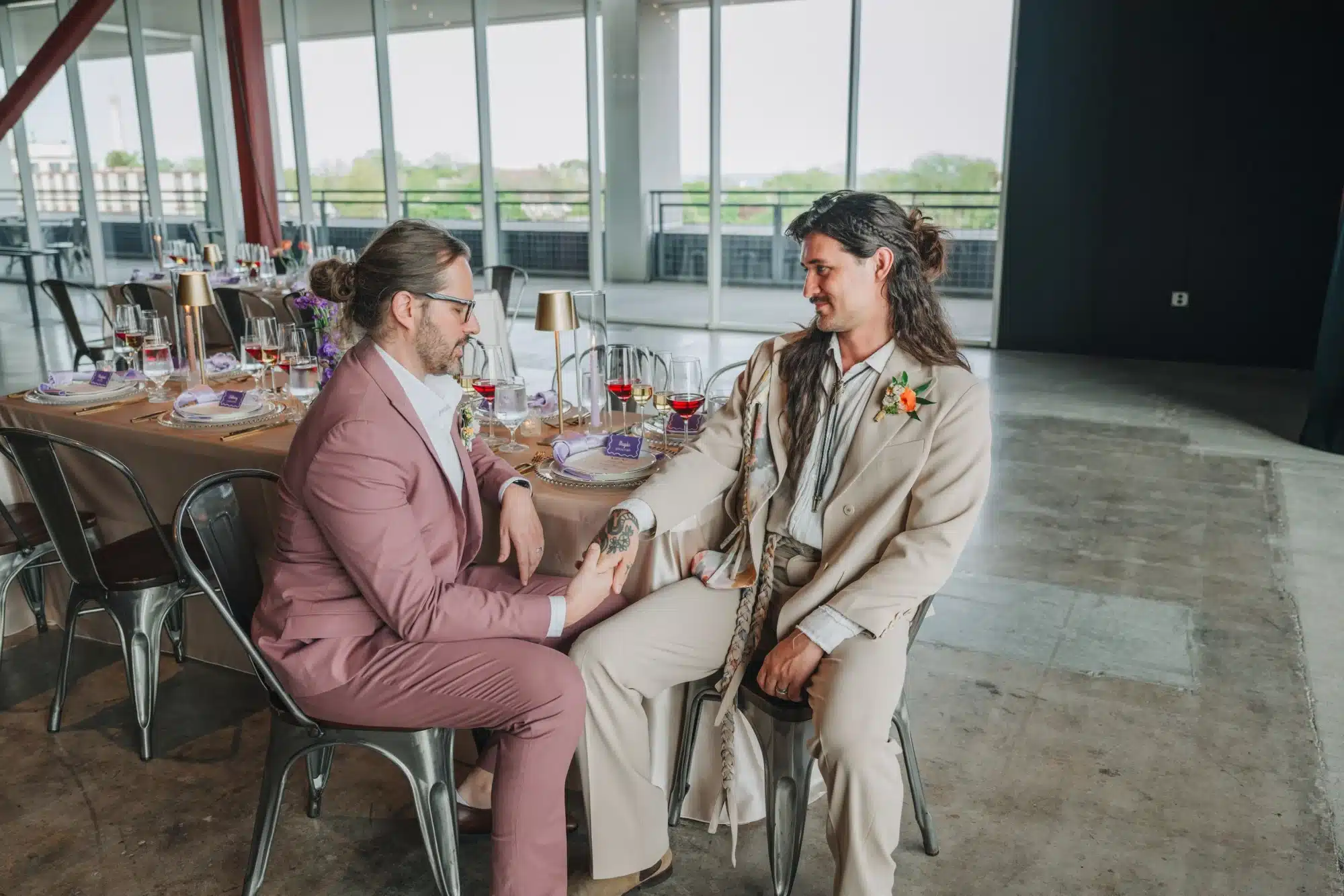 Grooms sit at wedding reception table at Jan Serr Studio. Grooms sit at wedding reception table at Jan Serr Studio.