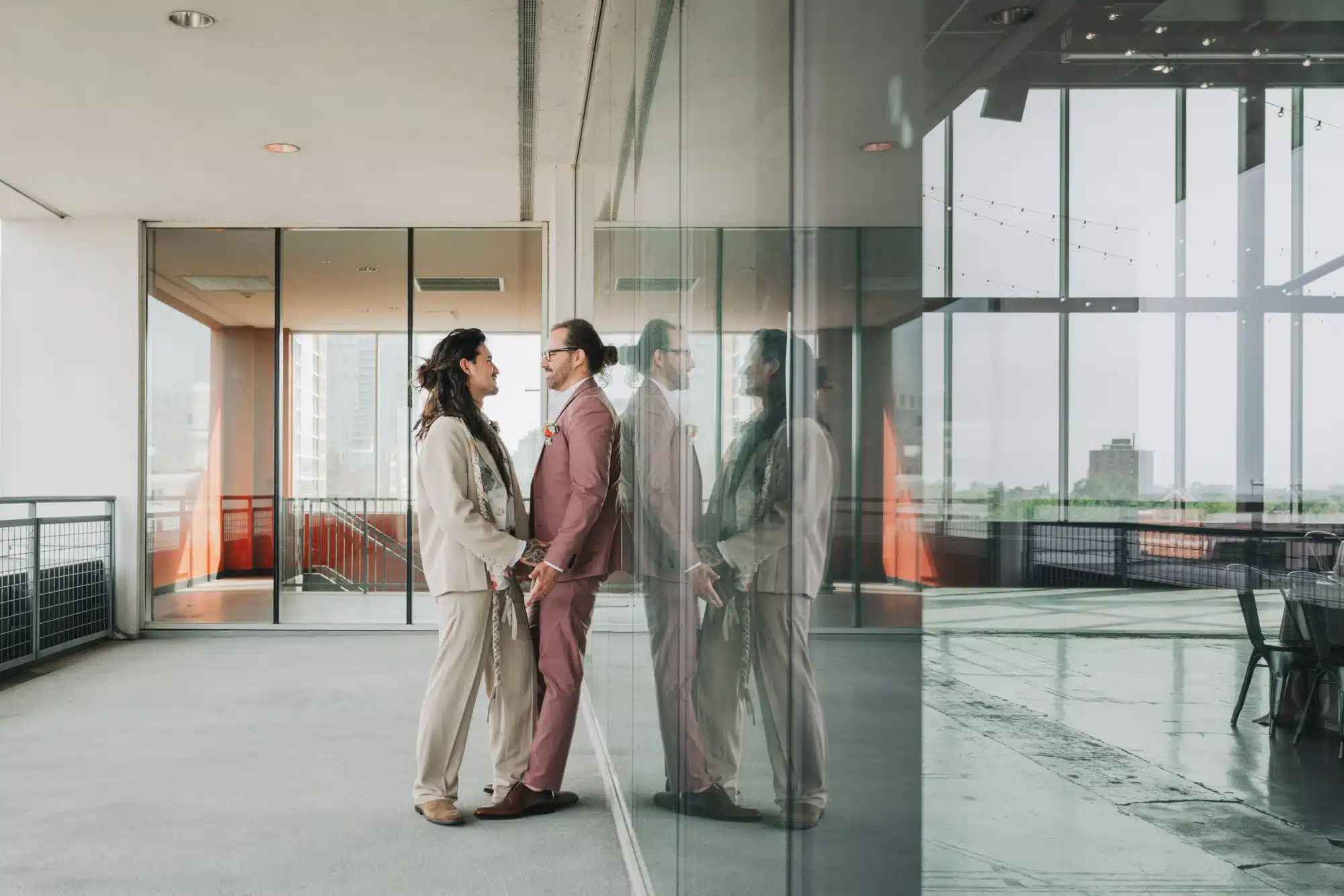 Grooms snuggle together on the balcony of Jan Serr Studio. Grooms snuggle together on the balcony of Jan Serr Studio.