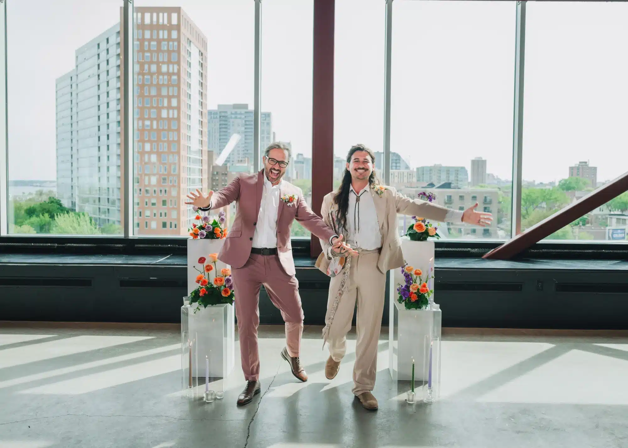 Grooms smiling and cheering at wedding ceremony at Jan Serr Studio. Grooms smiling and cheering at wedding ceremony at Jan Serr Studio.