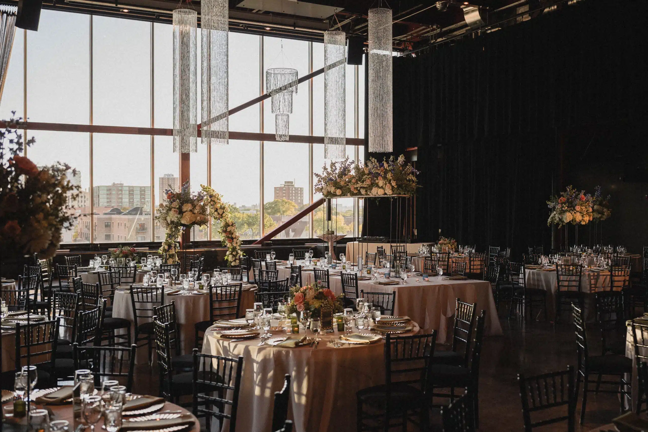 Jan Serr Studio setup for wedding reception with large floral centerpieces.