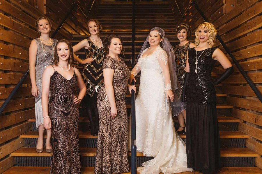 Roaring twenties inspired bridal party look- Bride and her bridesmaids pose on staircase at the Schauer Arts Center in Harford, WI
