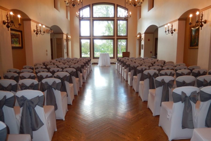 Room at The Polish Center set up for wedding ceremony with covered chairs