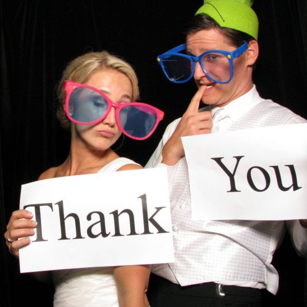 Cute Bridal and Groom image holding Thank You signs