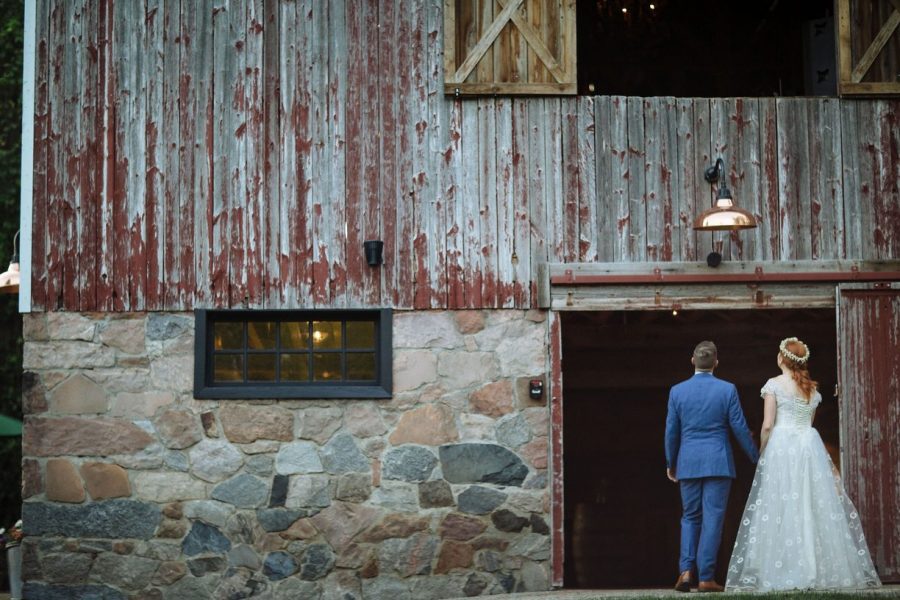 Bride and Groom walking into the barn at the farm at Dover
