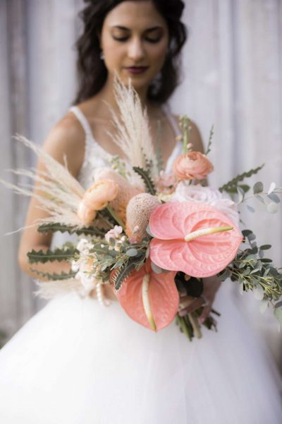 Bright Boho Wedding Bouquet. Pampas grass with coral unique flowers. Done by Bank of Flowers in Wisconsin.