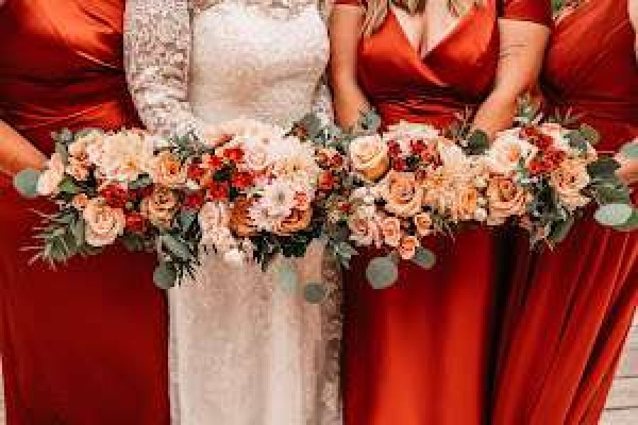 Reds and blushes complete this bridal party floral by Bank of Flowers in WI.