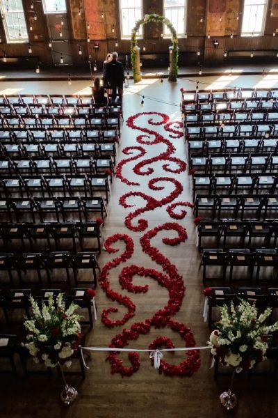Intricate flower pedals arranged on ceremony aisle | Belle Fiori- Milwaukee, WI