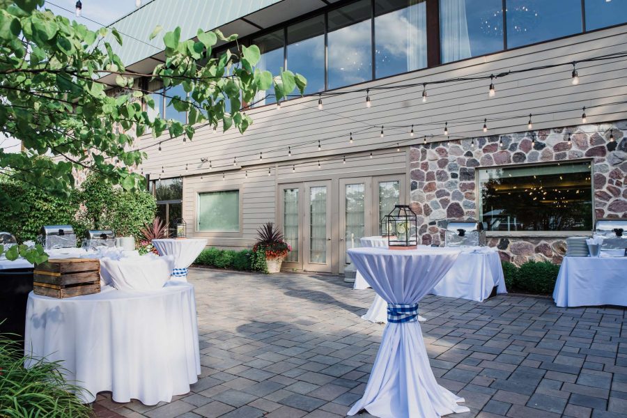 The Aspen Ballroom patio at The Ridge Hotel in Lake Geneva with high tables for cocktail hour