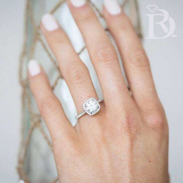 Engagement Ring on hand with white nail polish