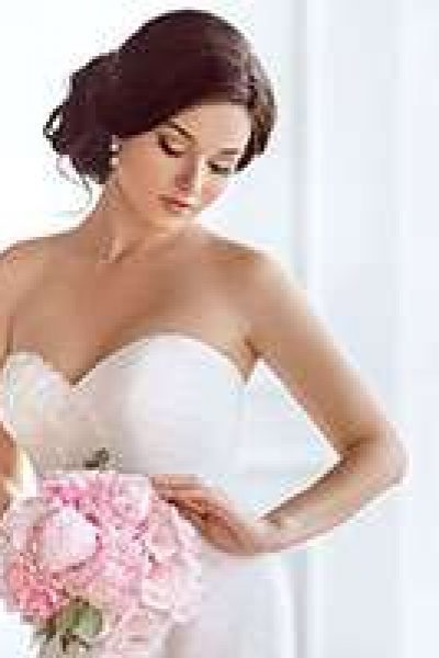 Strapless wedding gown with bride holding floral bouquet
