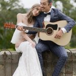 Groom plays music on his guitar to his bride