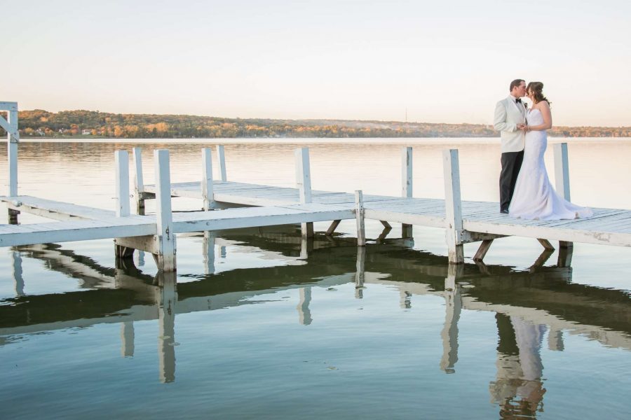 Bride and groom kissing at the Ridge Hotel marina in Lake Geneva, WI