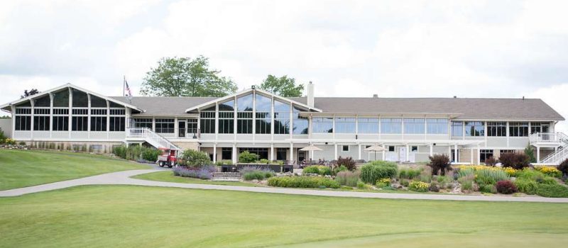 view from the golf course at West Bend Country Club shows the bright windows and picturesque setting