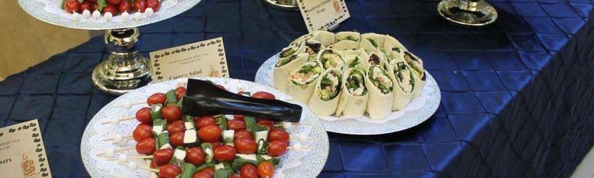 Appetizers on table with dark blue linens