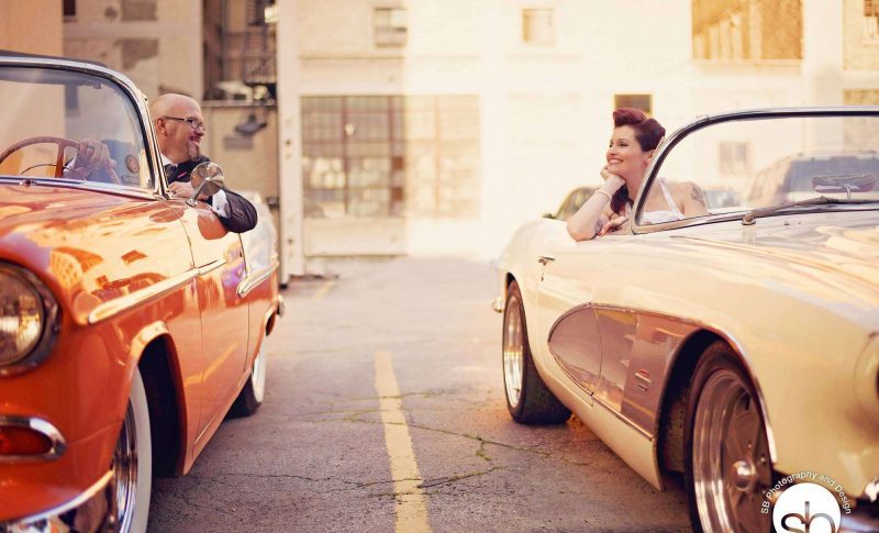 Bride and groom both in classic cars gaze at each other | SB Photography and Design