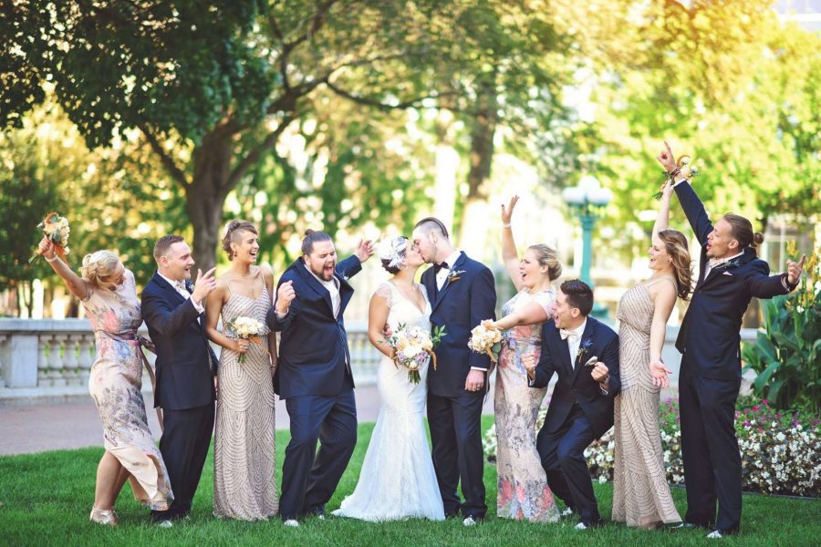 Wedding party cheering on the kissing wedding couple | SB Photography and Design